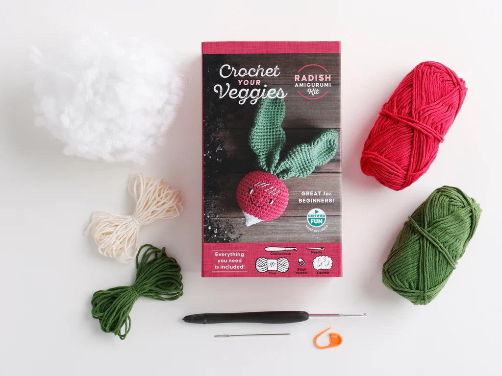 parts of a crochet kit for a radish arranged on a white background