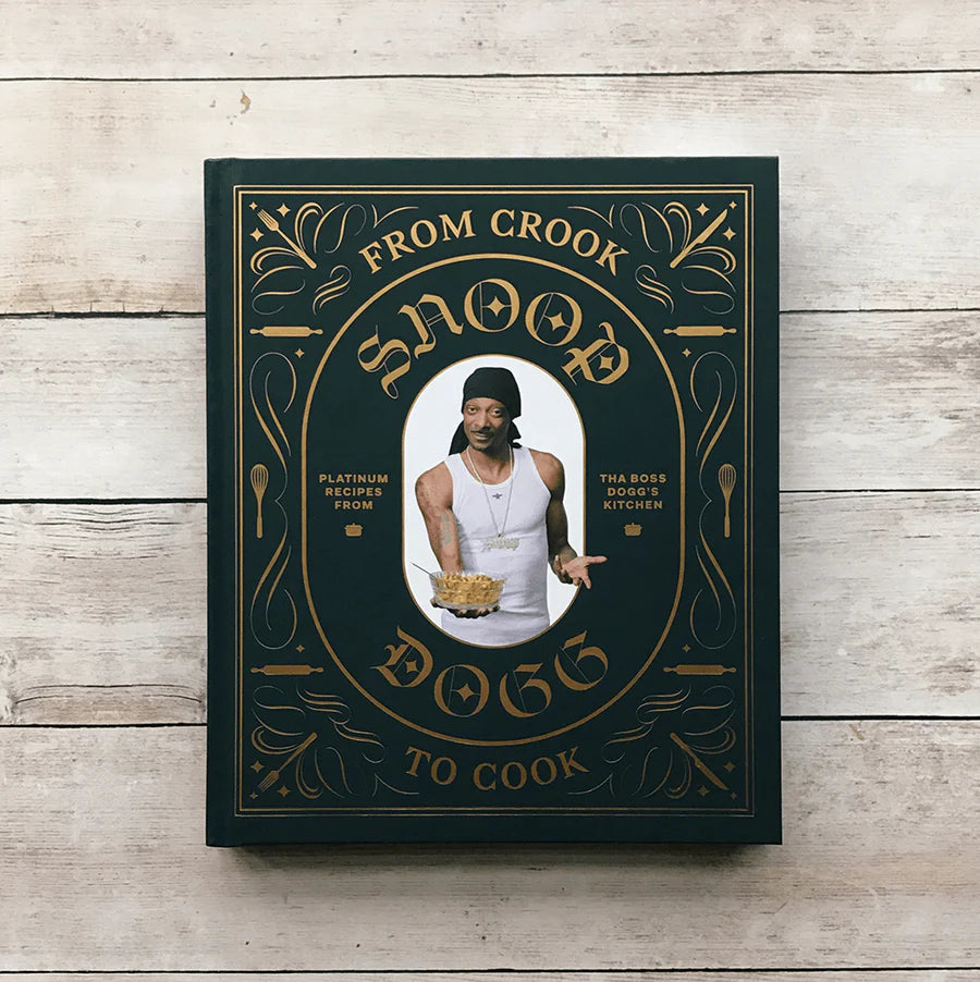 front cover of snoop dogg's cookbook with a portrait of him printed on it.