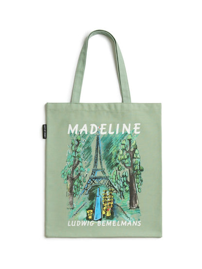green tote bag featuring an image of Madeline walking towards the Eiffel Tower
