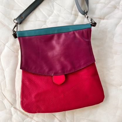 greta bag with plum flap over fuchsia body.