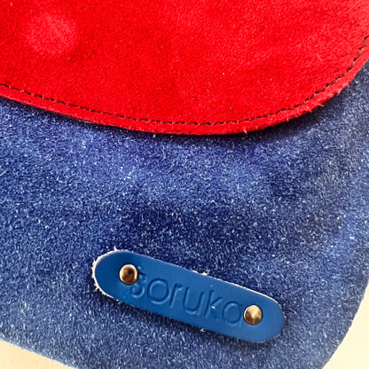 close-up of corner of purse showing "soruka" logo.