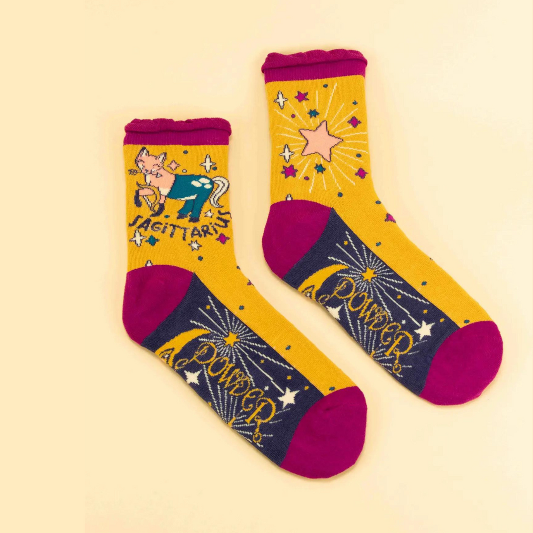 yellow sagittatius socks with fox design.