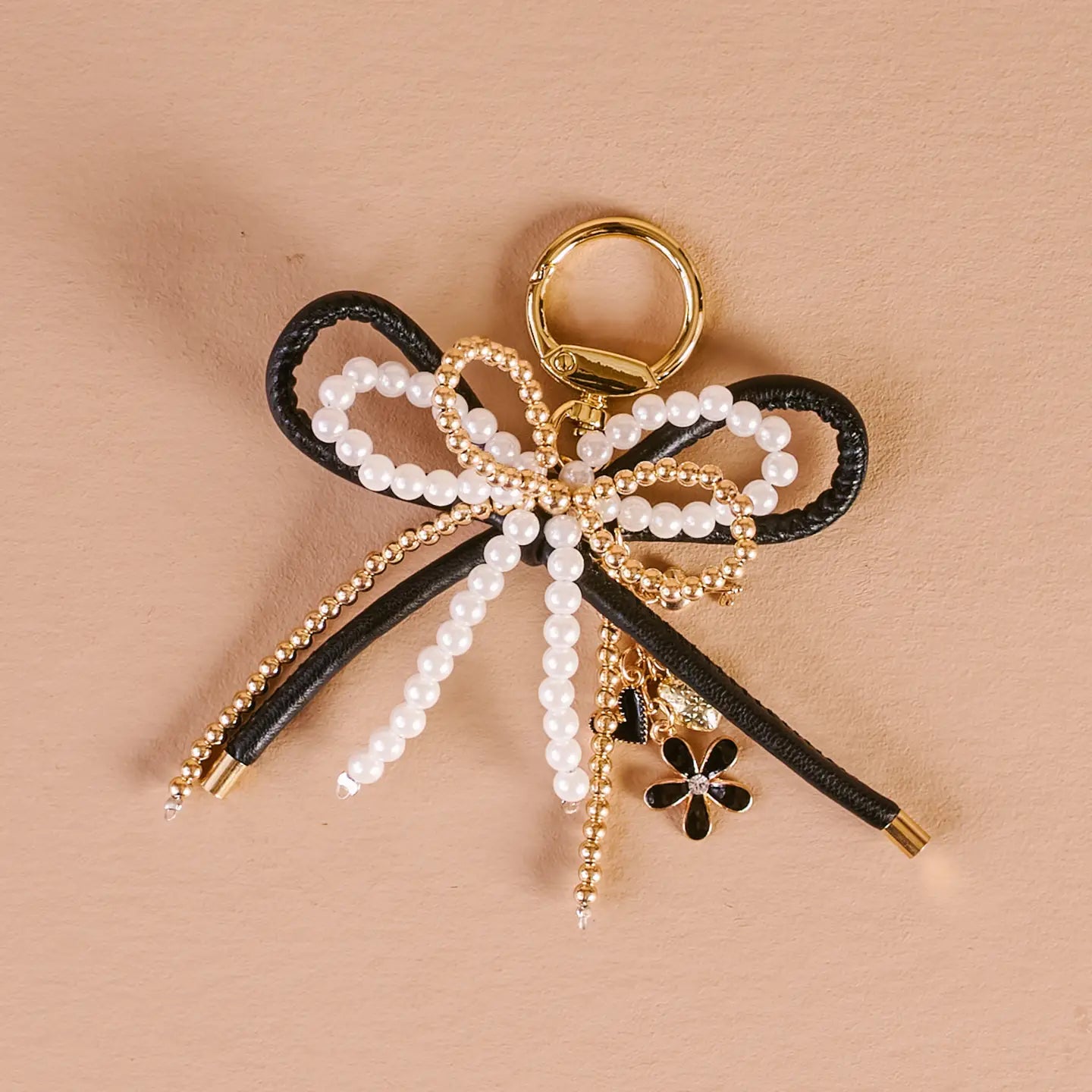 luxe glam  Layered Bows Bag Charm on a beige background