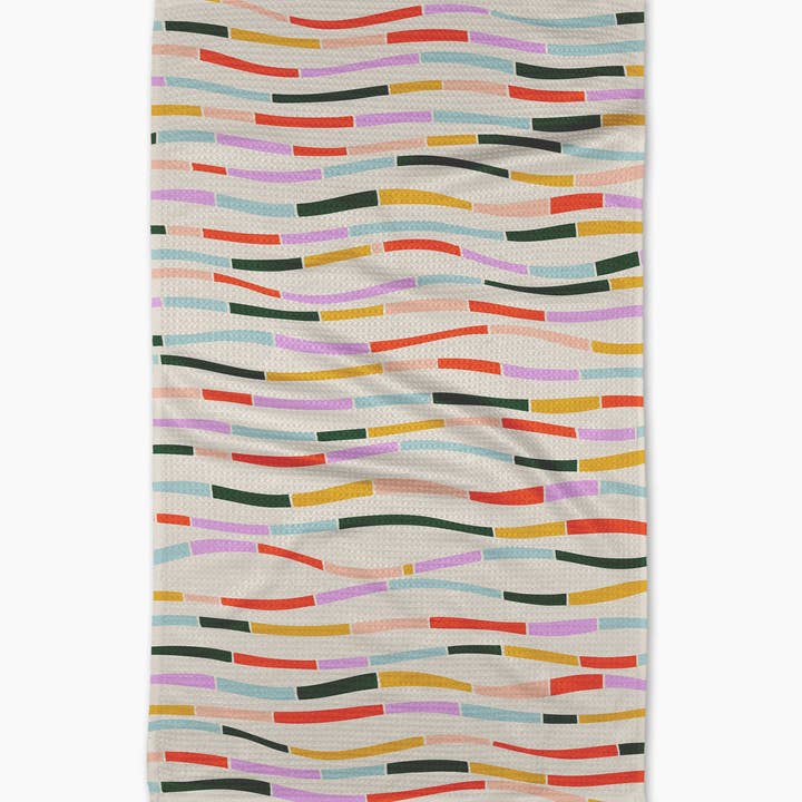 Colorful Currents Tea Towel laying on a white surface