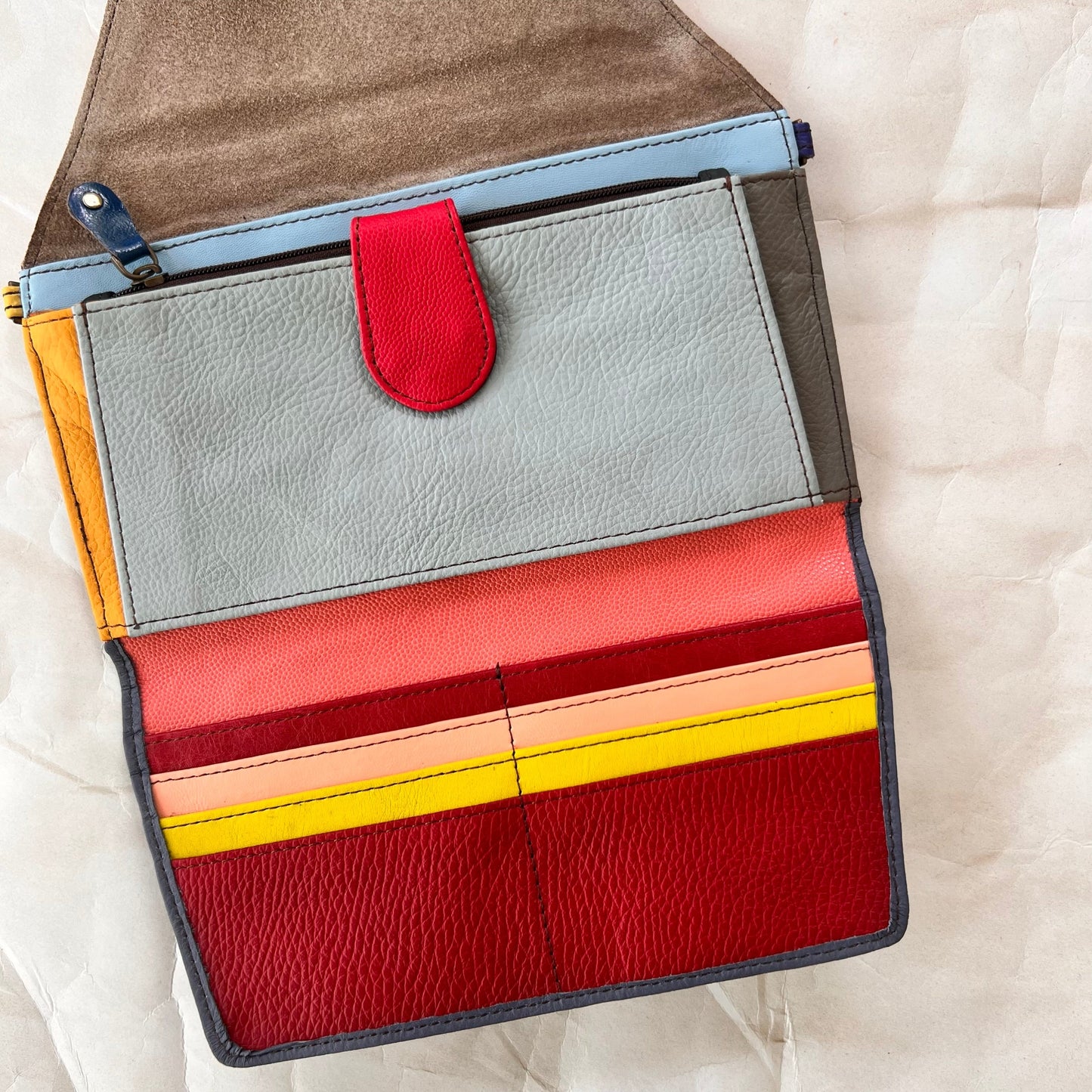 interior view of secret clutch wallet showing colorful card slots and other pockets.