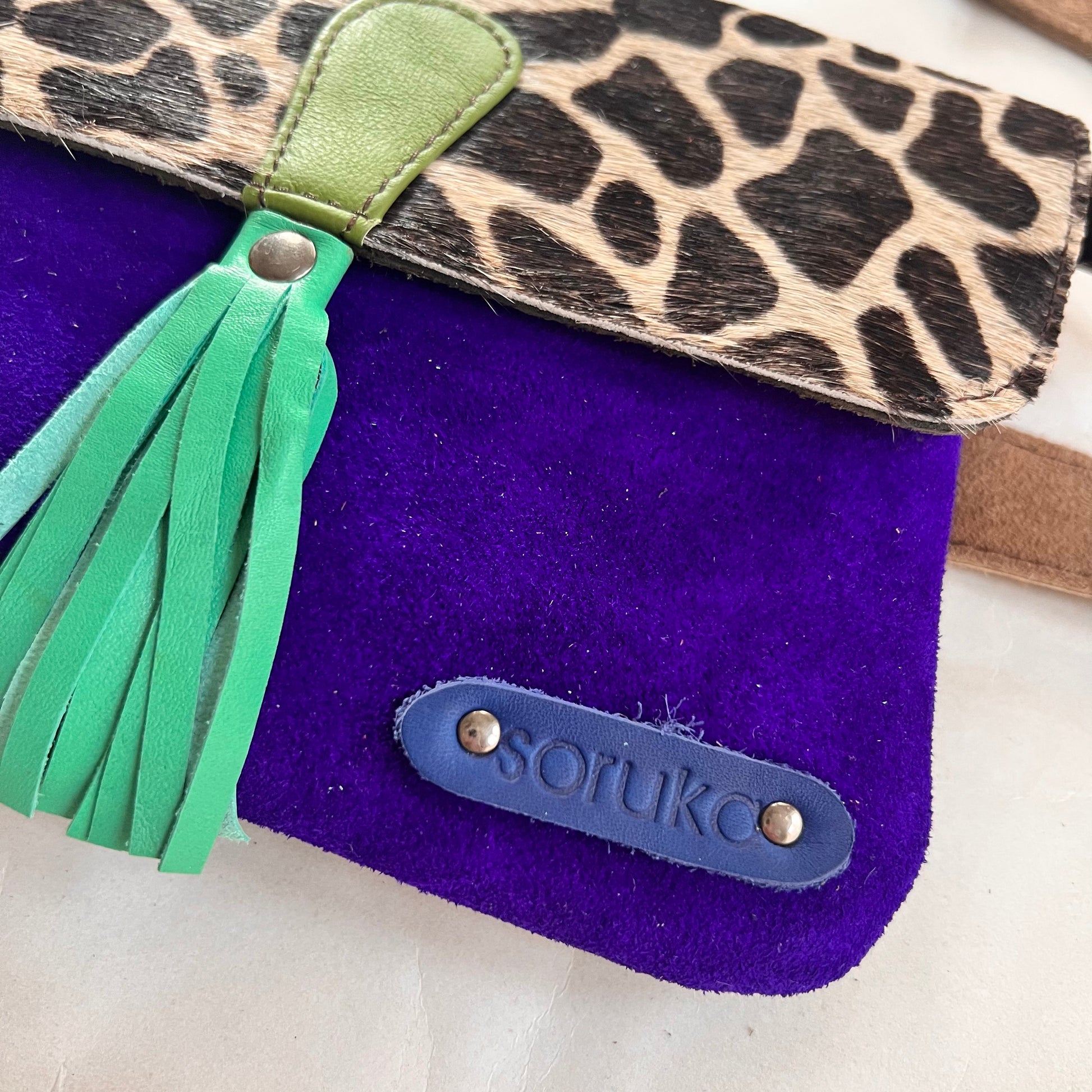 close up of corner of juliette bag with patch stamped with "soruka" logo.