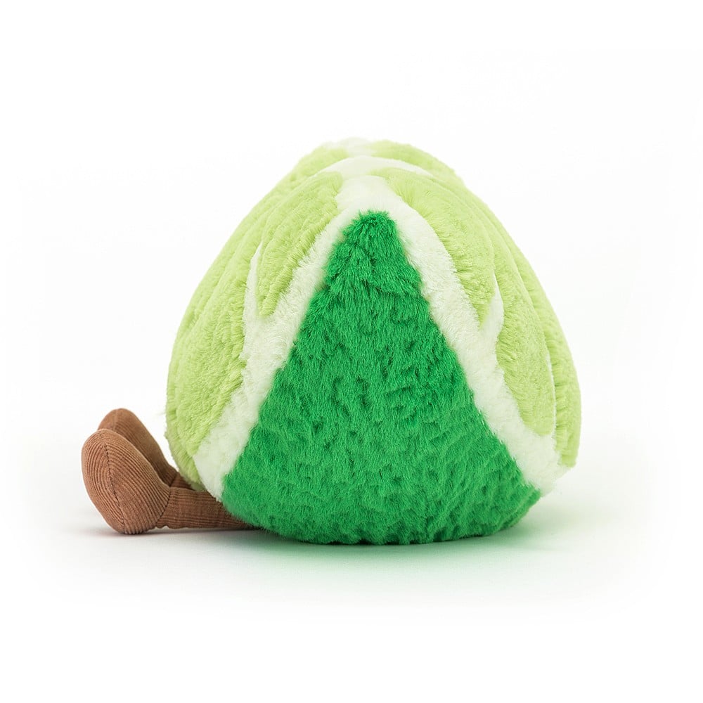 side view of plush lime slice with smile face and legs on white background.