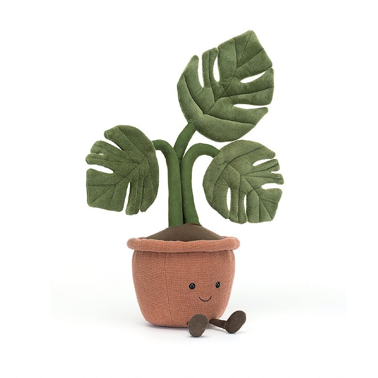 plush potted plant with three leaves, a smile face, and legs on a white background