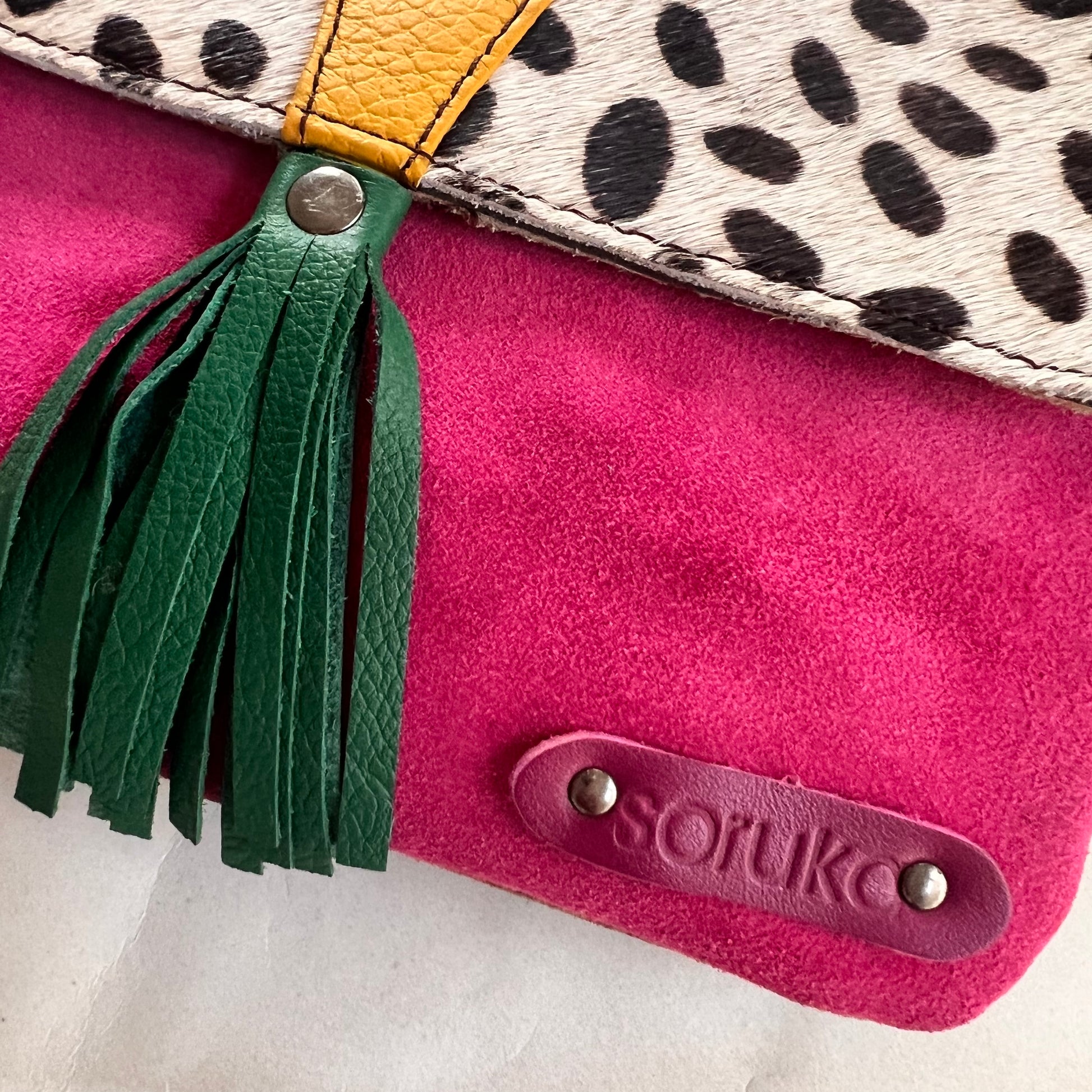 close up of corner of juliette bag with patch stamped with "soruka" logo.