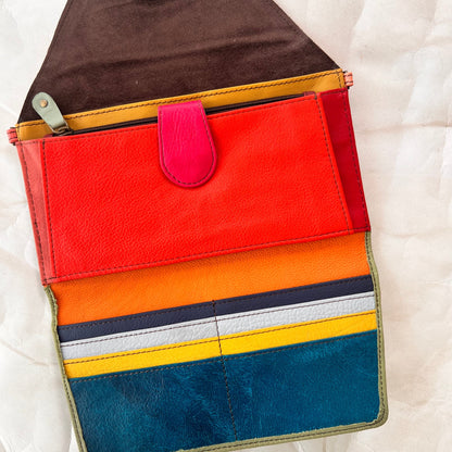 interior view of secret clutch wallet showing colorful card slots and other pockets.