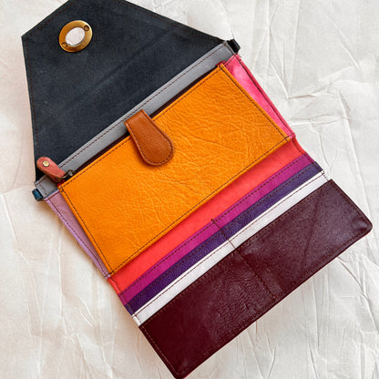 interior view of berry secret clutch wallet showing colorful card slots and other pockets.