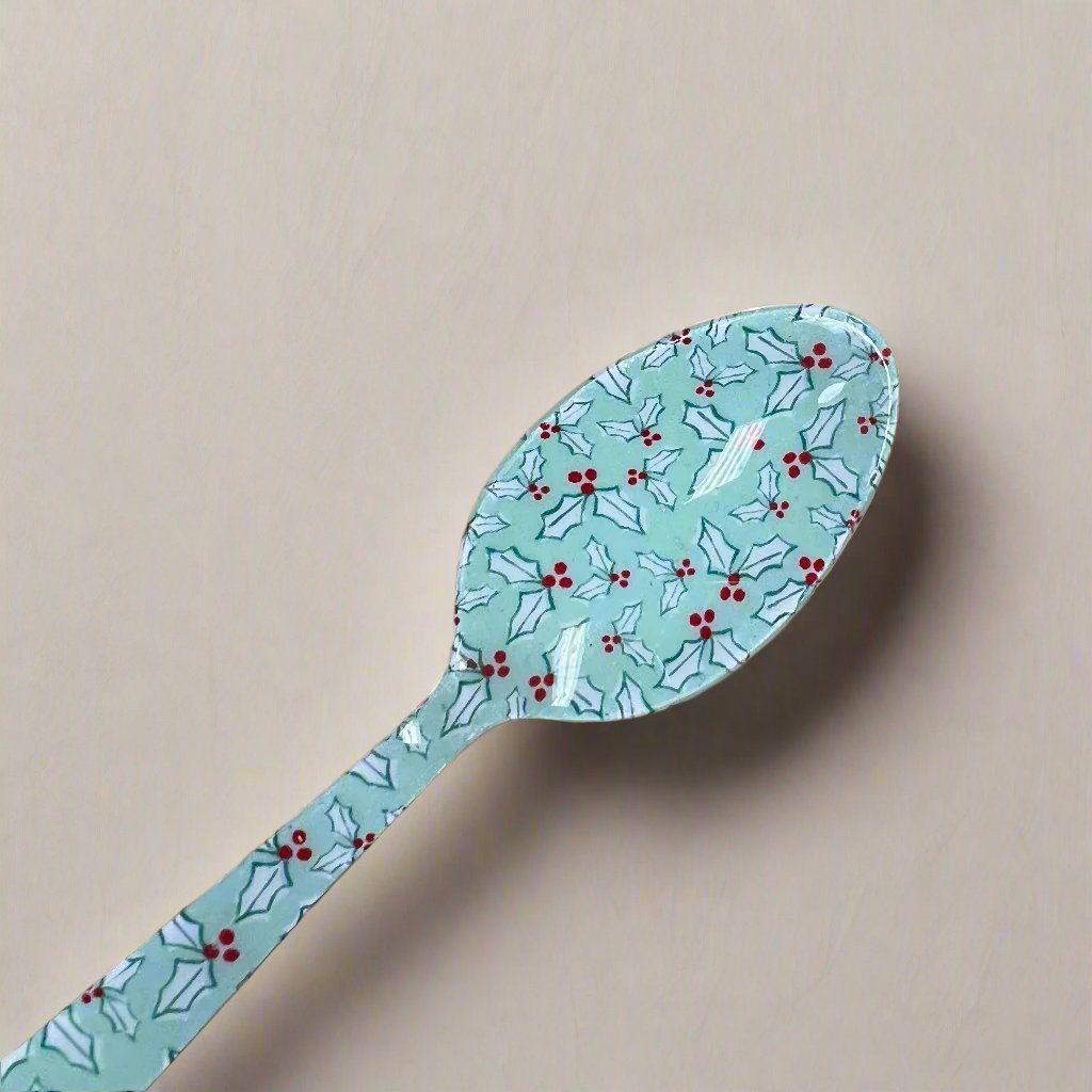 mint green spoon with holly pattern.