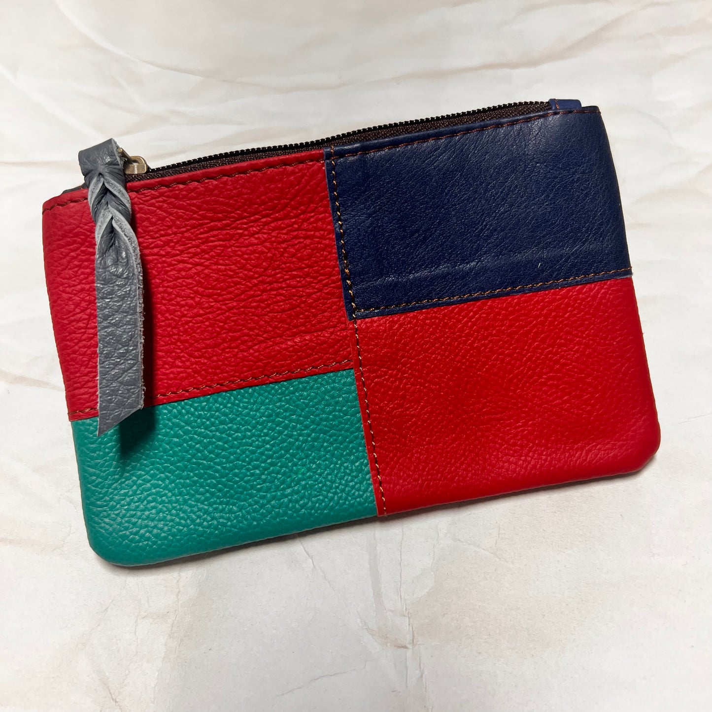 zahra pouch with red, blue,  and green patchwork.