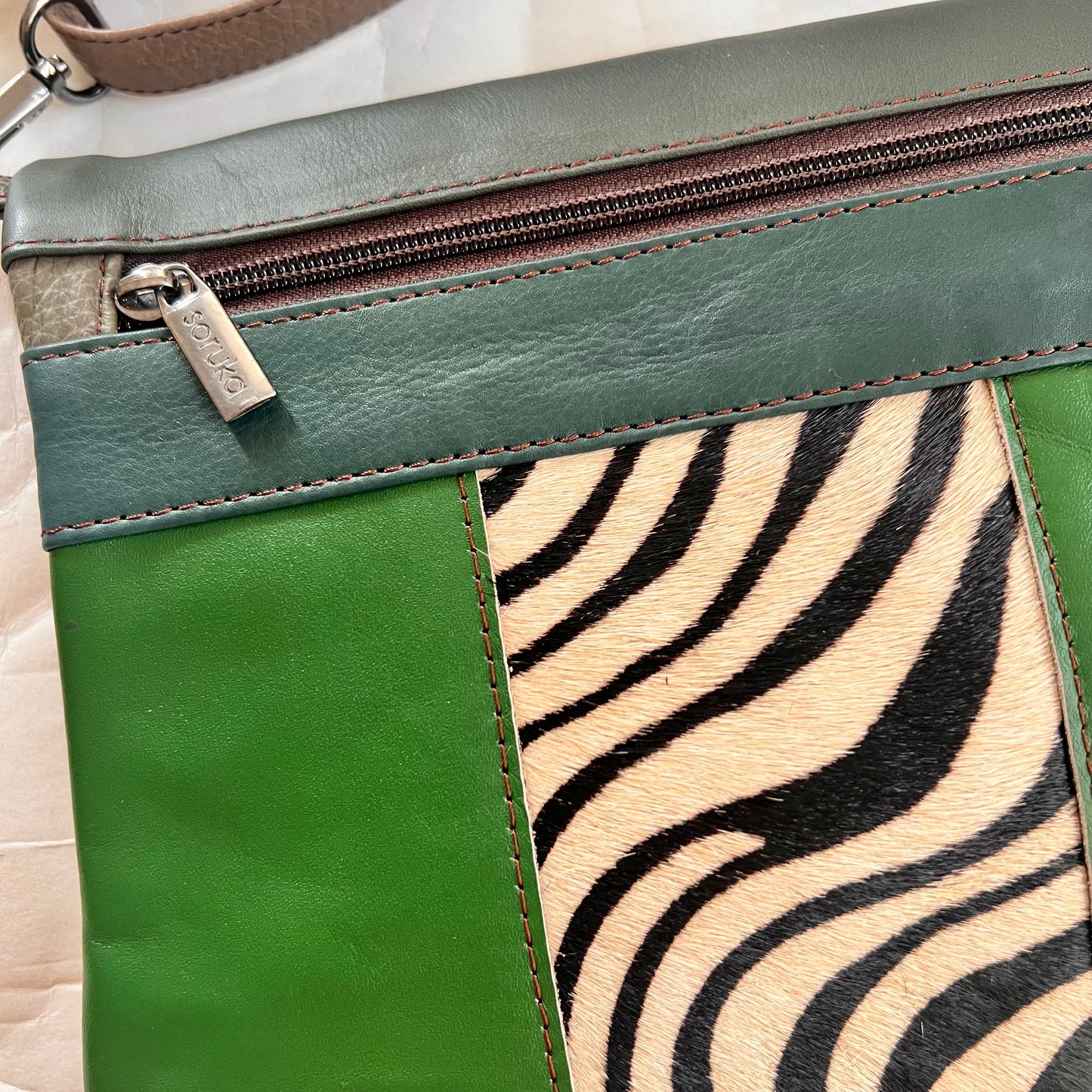 close-up of green and animal print greta.