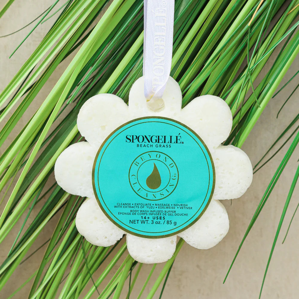 Spongelle Beach Grass bath sponge with green label on a grass background