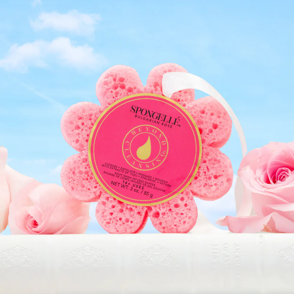 Pink flower-shaped sponge with a label on a blue background with pink roses.