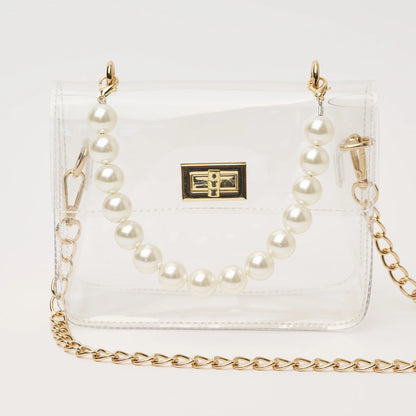 clear handbag with short pearl handle and longer gold chain crossbody strap. The bag has gold hardware and a square shape.