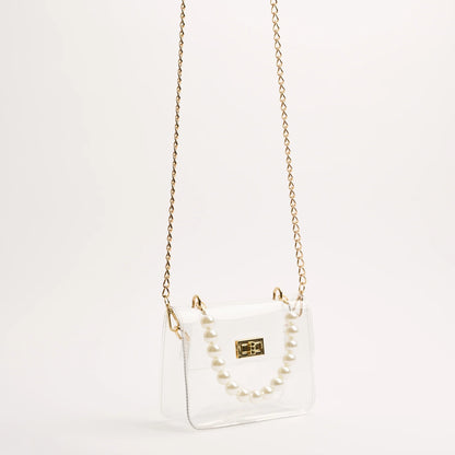 audrey stadium bag with pear and gold accents handing from the gold chain crossbody strap