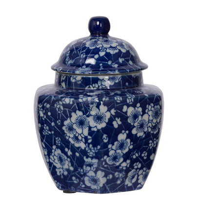 small round blue jar with lid and white flower design