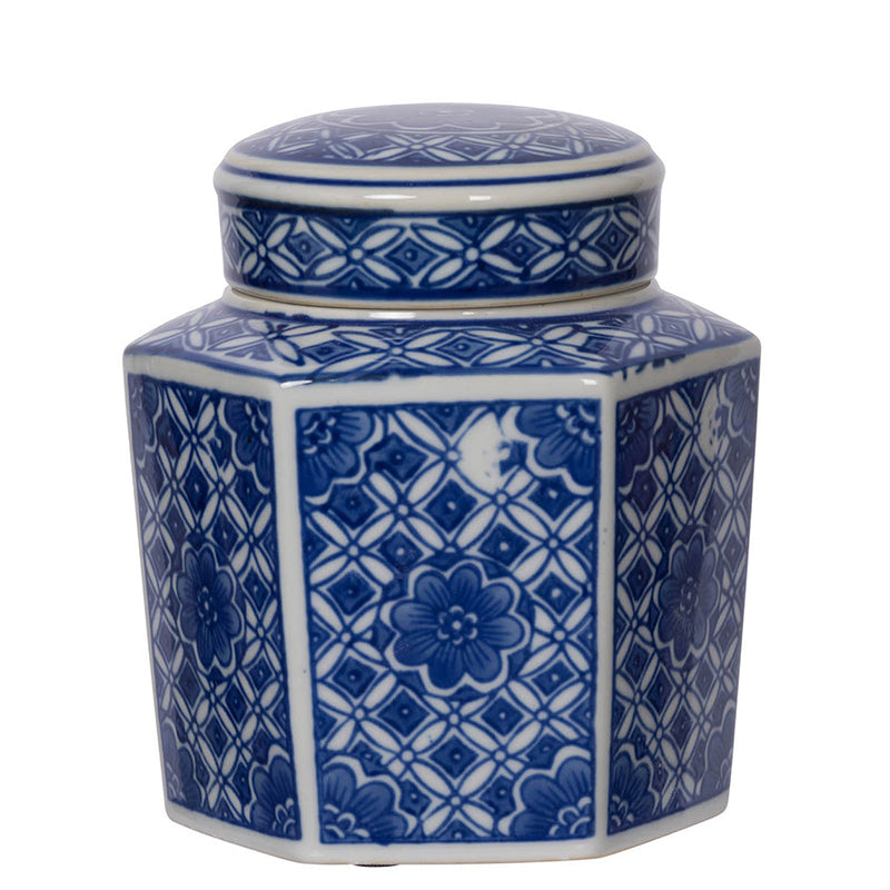 small white jar with hexagon shape, lid, and blue floral and geometric design