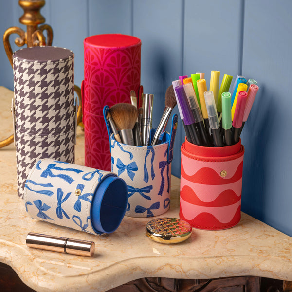 open view of blue bows travel pod filled with make-up bushes