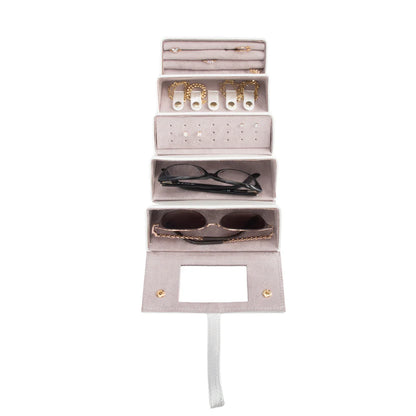 pearl white jewelry case filled with glasses and jewelry