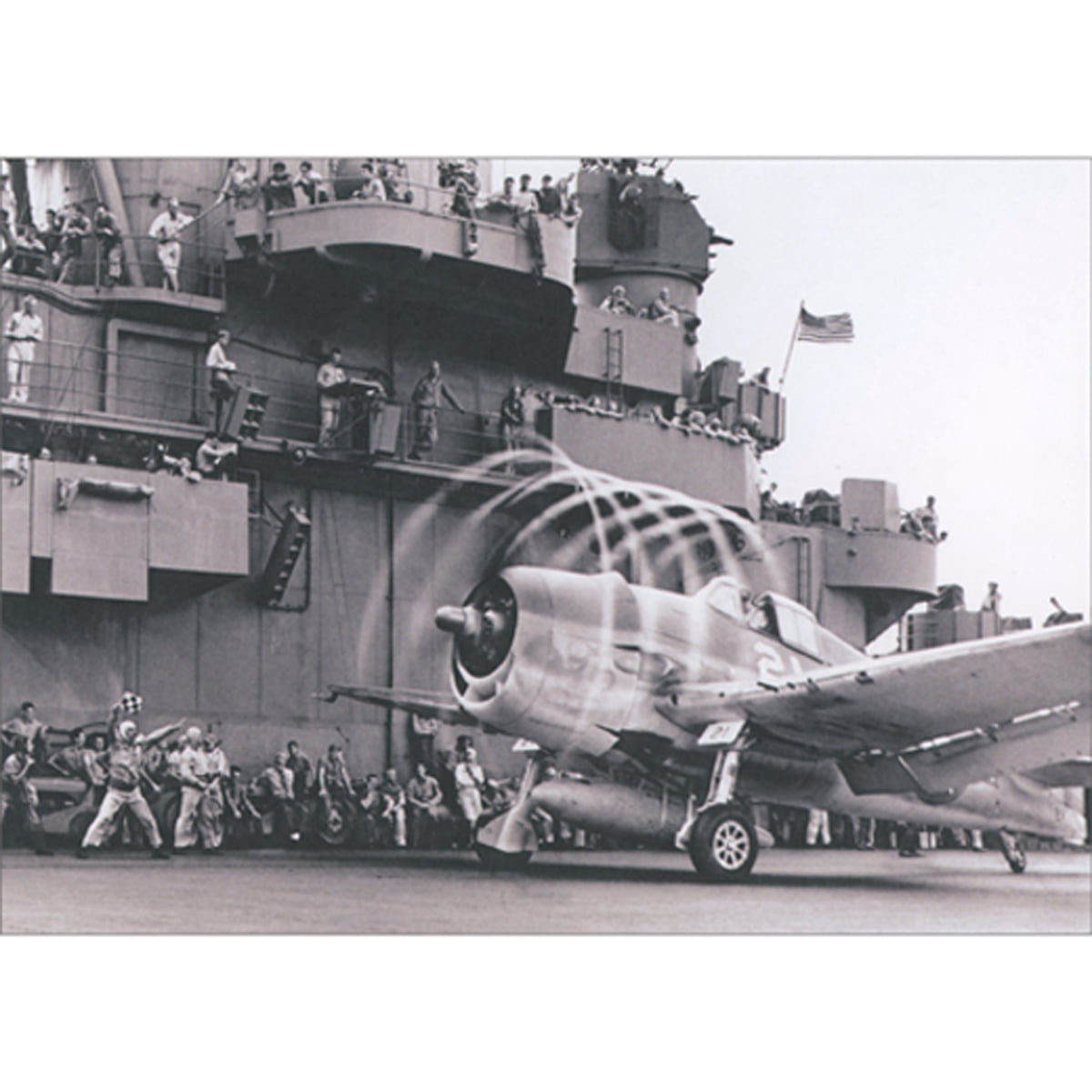 front of card is black and white photo of an airplane on an aircraft carrier