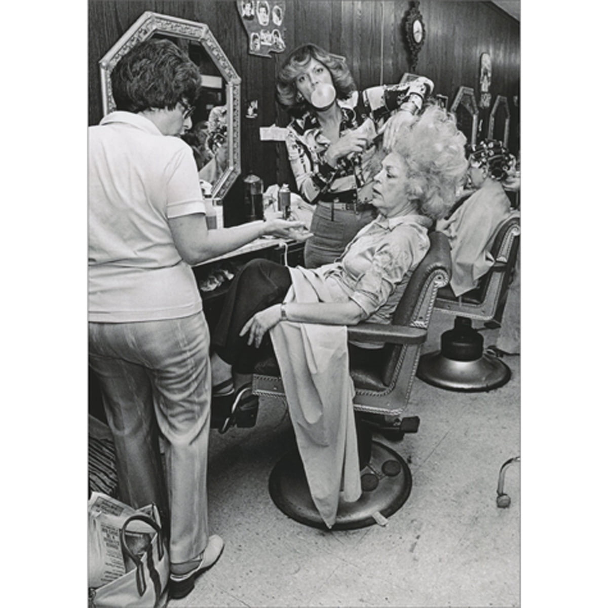 front of card is black and white photo of women in a hair salon