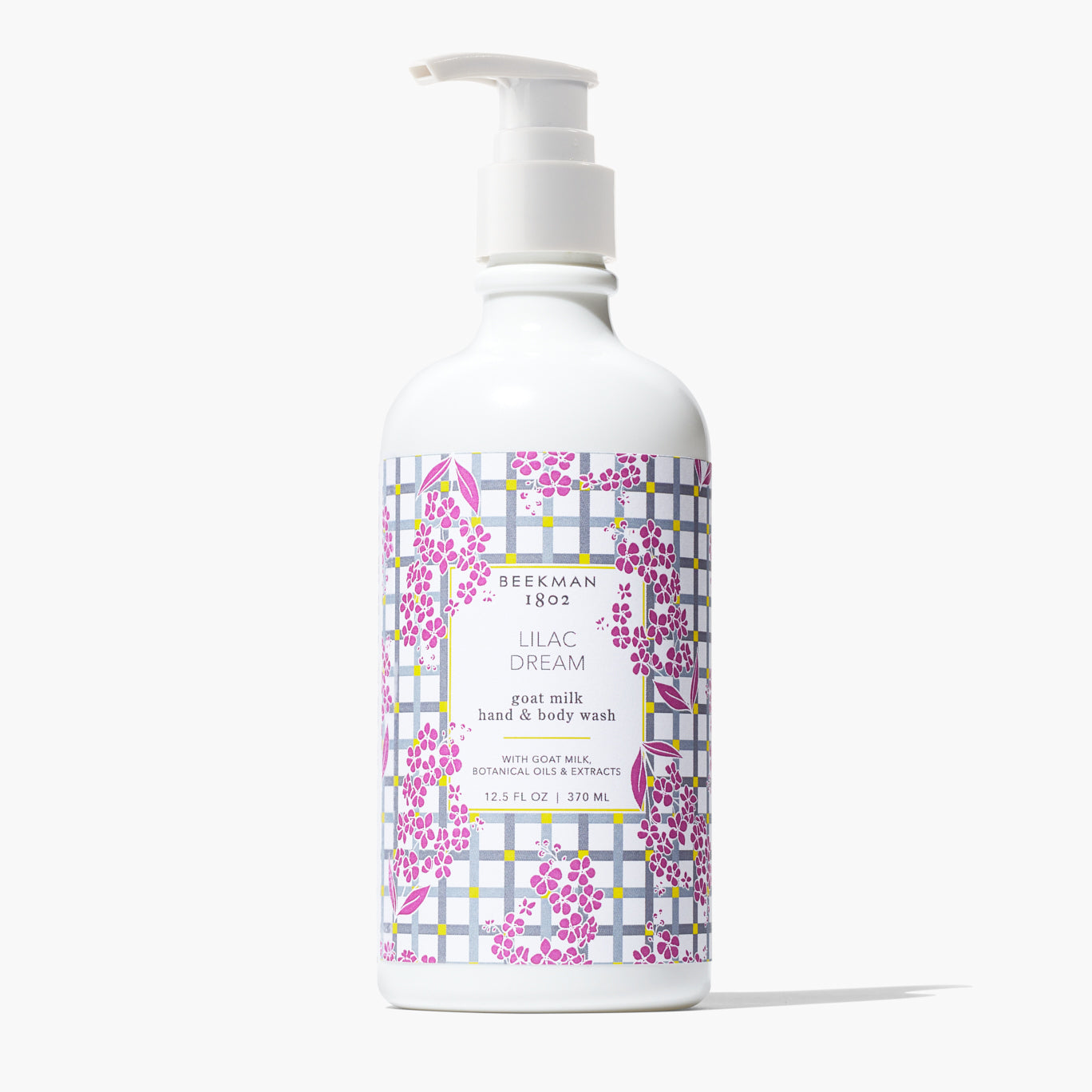 bottle of lilac dream hand and body wash printed with a grey plaid background and lilac flowerslable.