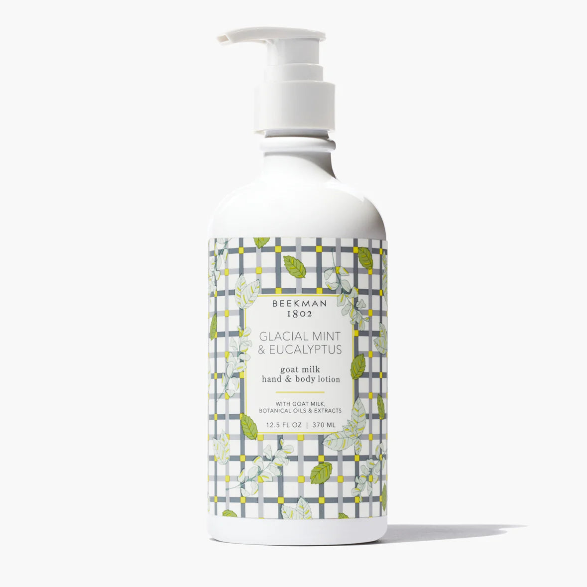 white pump bottle of Glacial Mint & Eucalyptus Goat Milk Lotion with a leaf and grey grid printed label