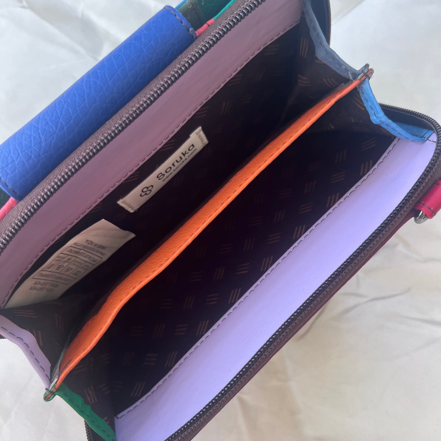 view of interior zippered compartment of blue Beatrice Clutch