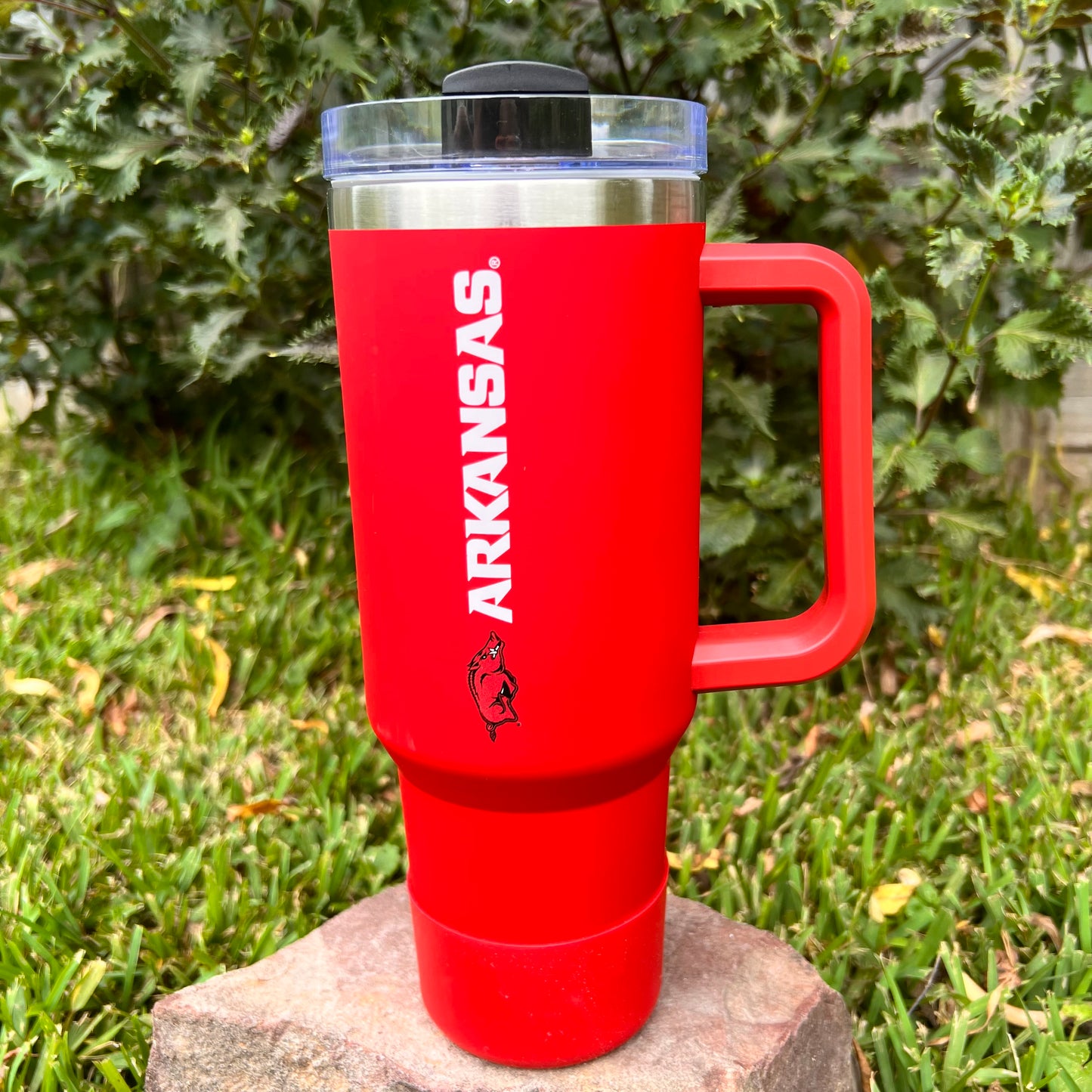 red tumbler with razorback logo and "arkansas" printed on it.