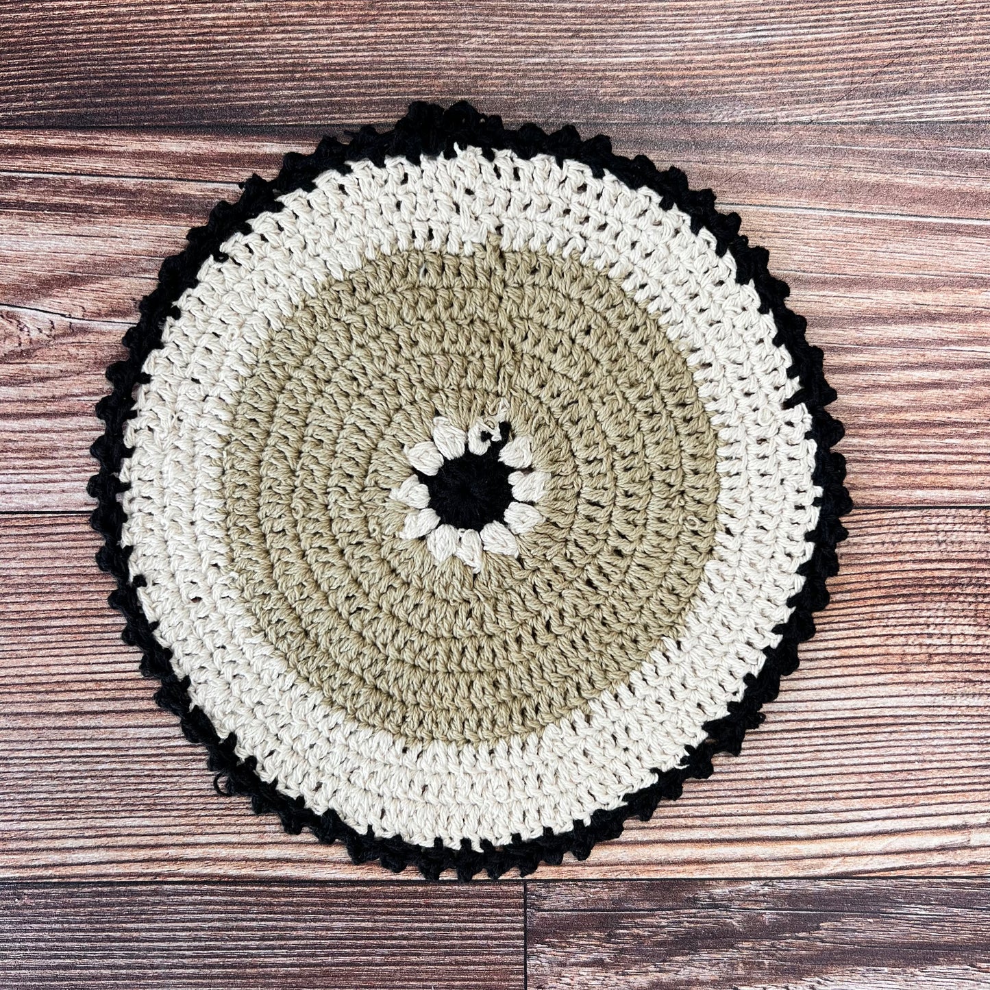 brown, off-white, and black crocheted pot holder.