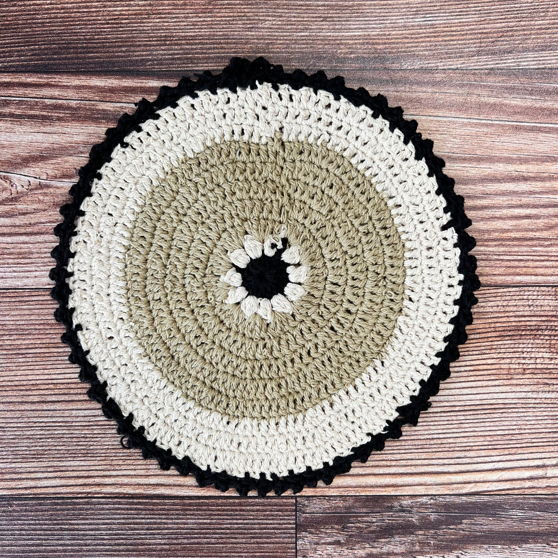 brown, off-white, and black crocheted pot holder.