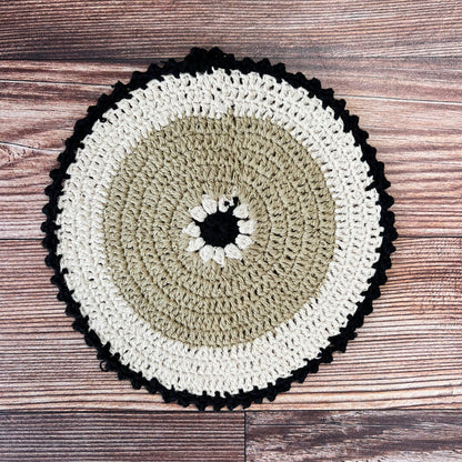 brown, off-white, and black crocheted pot holder.