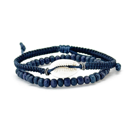 A set of blue beaded bracelets with metal and shell accents and adjustable straps.