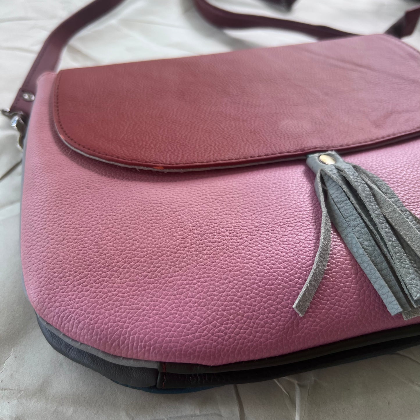 bottom view of blue tassel Lola Reversible Crossbody