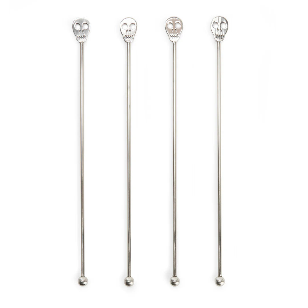 4 skull cocktail stirrers in a row on a white background.