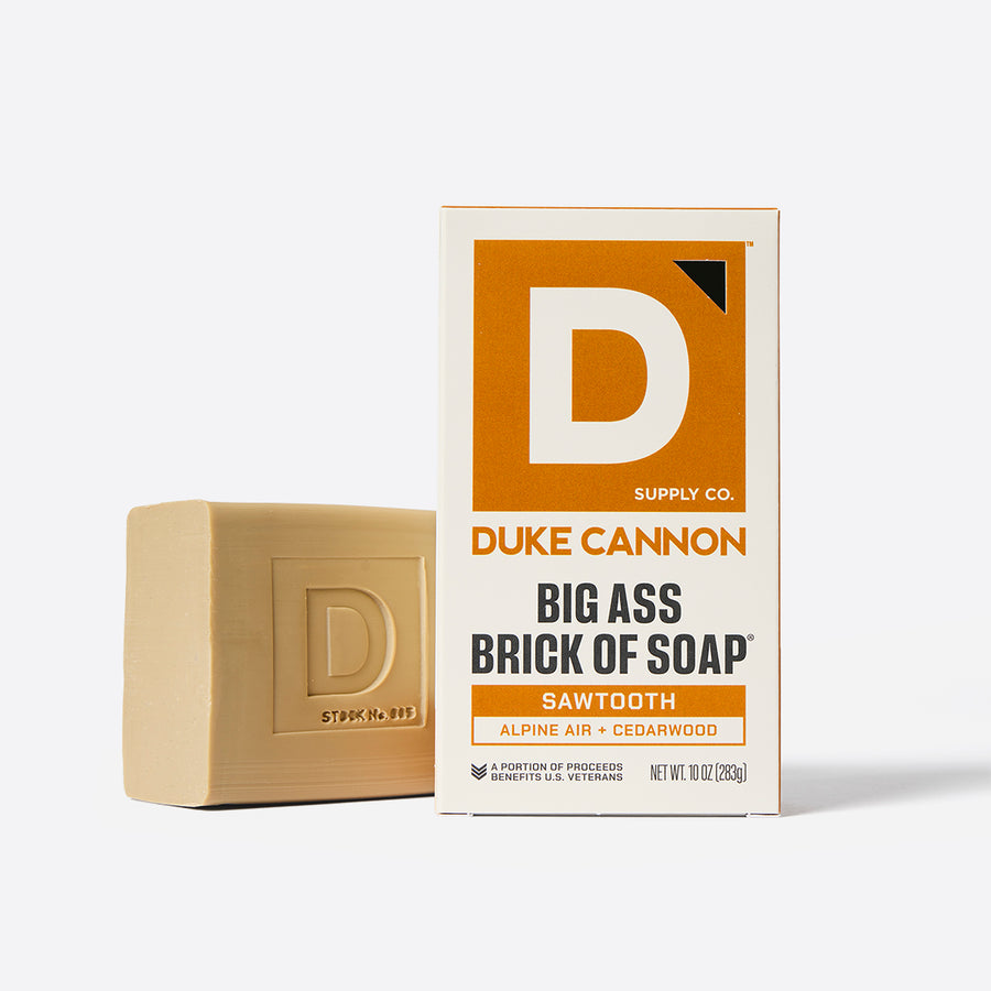Bar of soap and its packaging with Duke Cannon branding on a white background