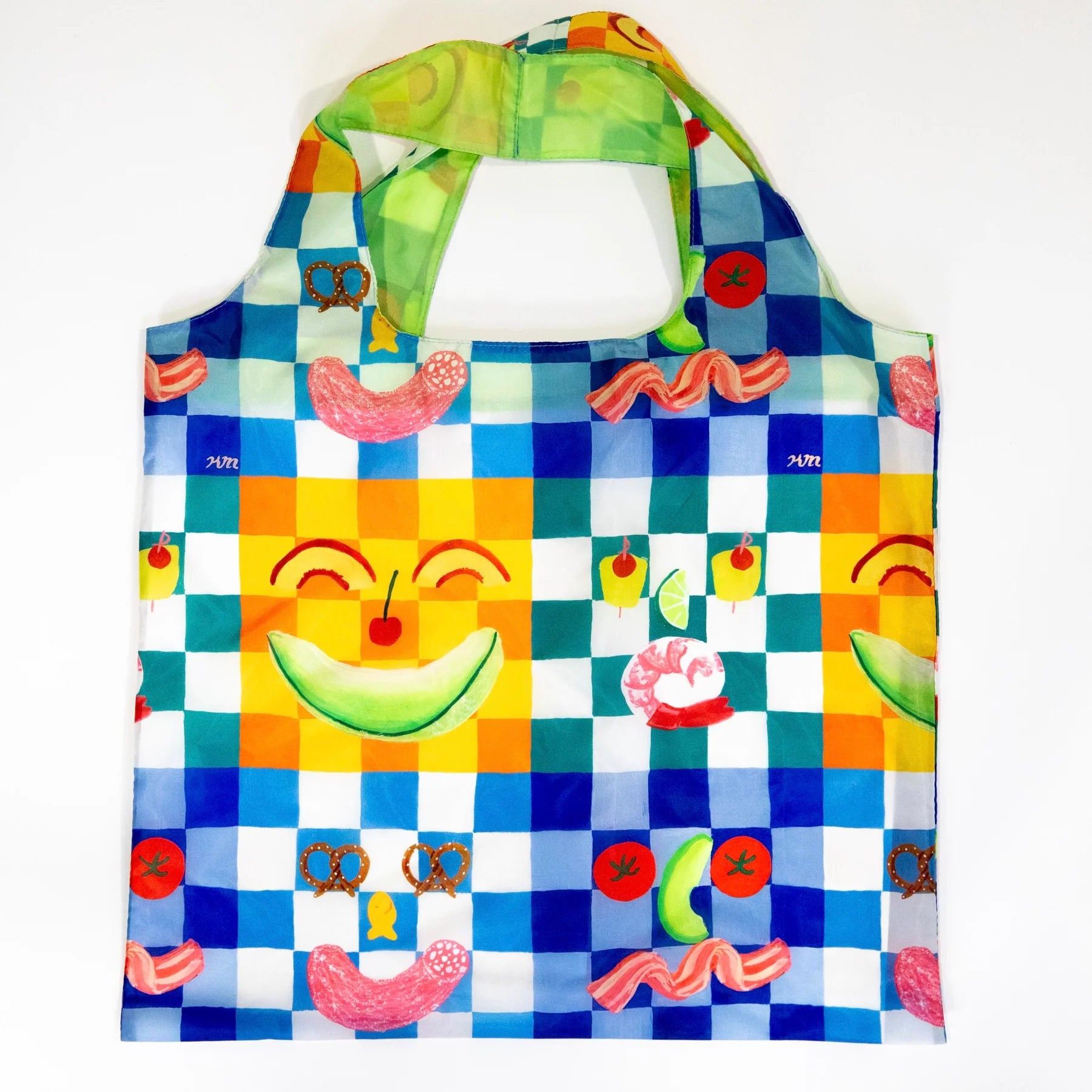 Kristina Micotti's Picnic Art Sack with a blue and white check background and fanny faces made out of food printed on it.