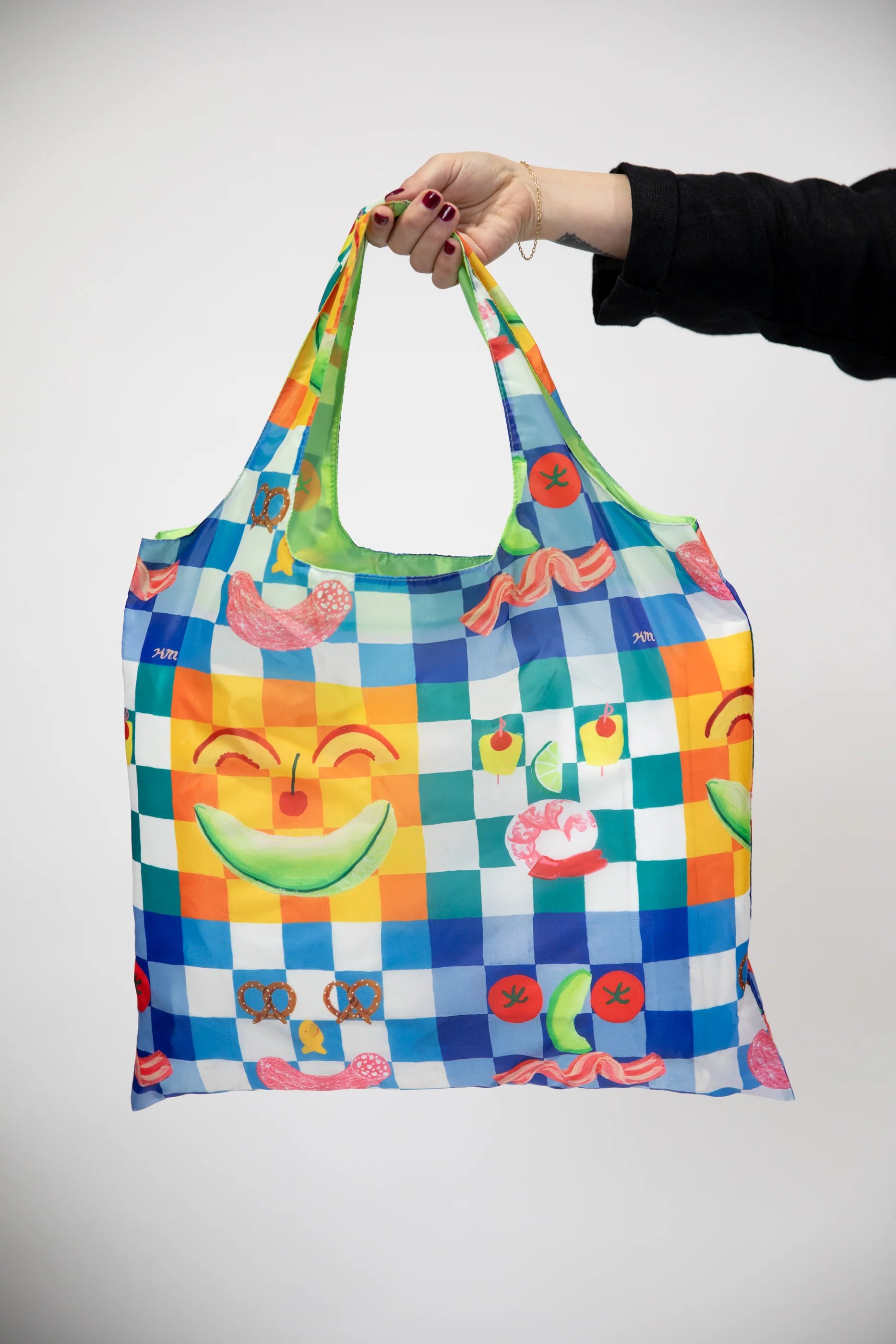 hand holding Kristina Micotti's Picnic Art Sack.