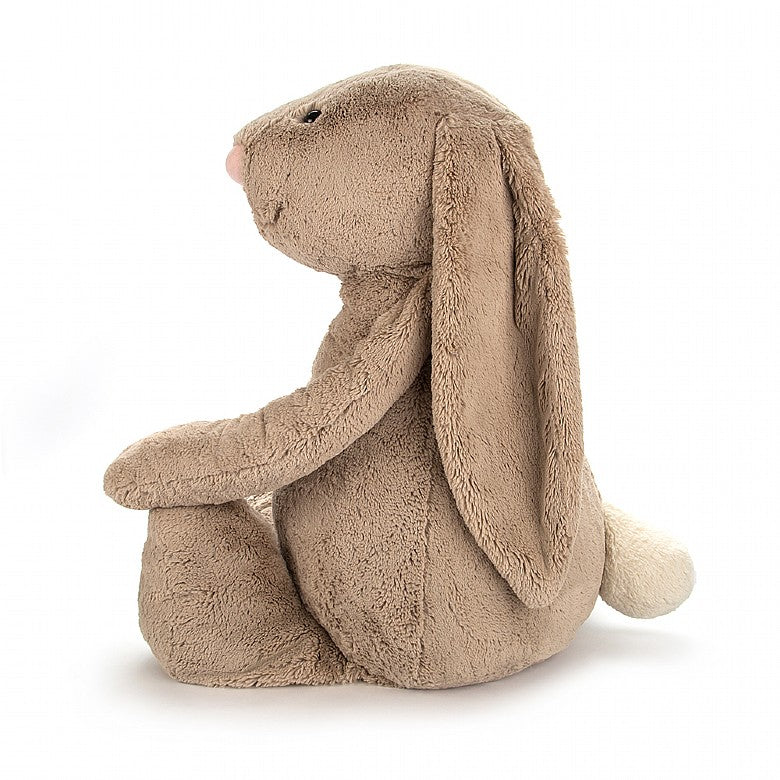 side view of the beige bashful bunny on a white background