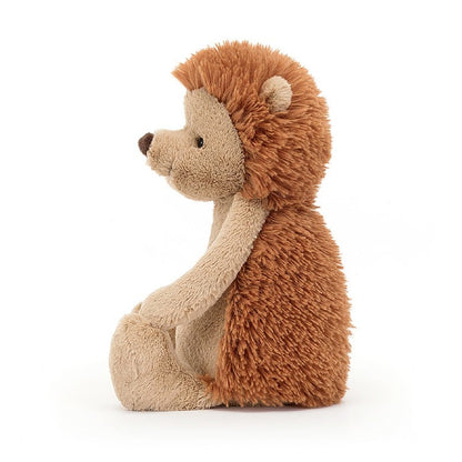 side view of the medium Bashful Hedgehog Plush Toy displayed against a white background