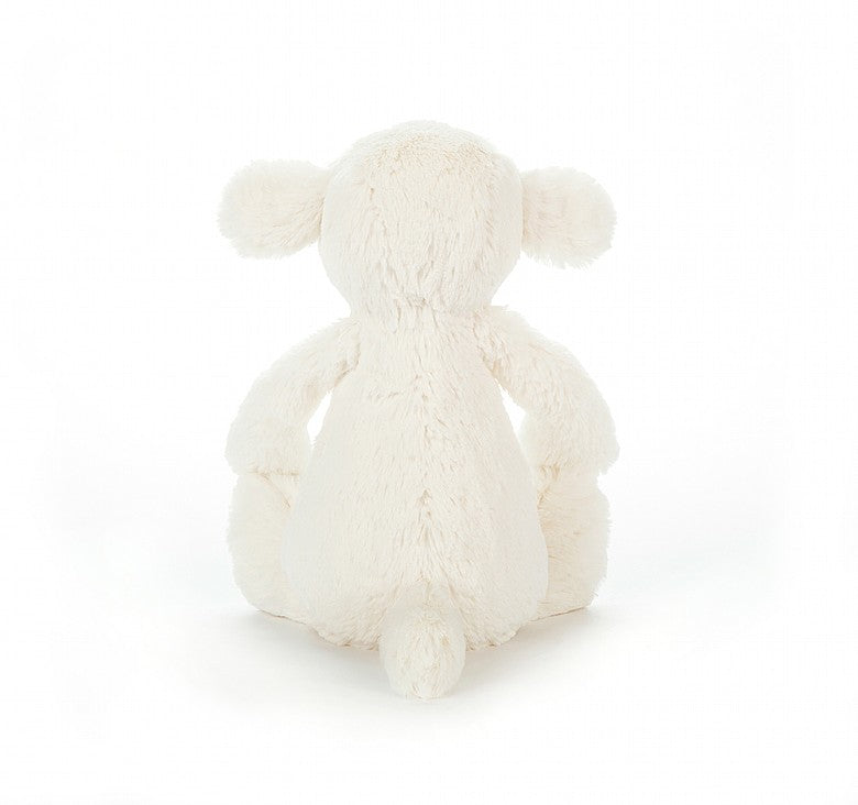 back view of bashful lamb plush toy on a white background