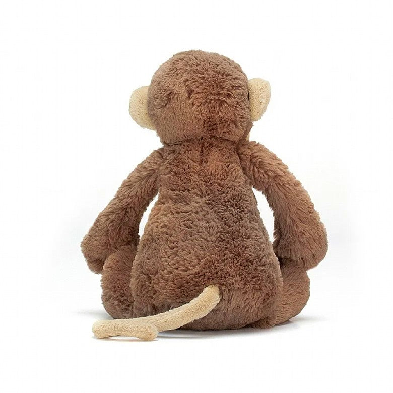 back view of the small bashful monkey plush toy on a white background