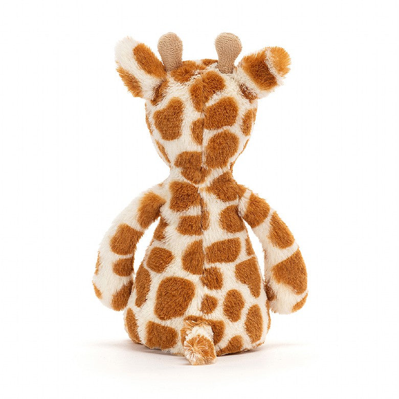 back view of small giraffe stuffed animal on a white background.