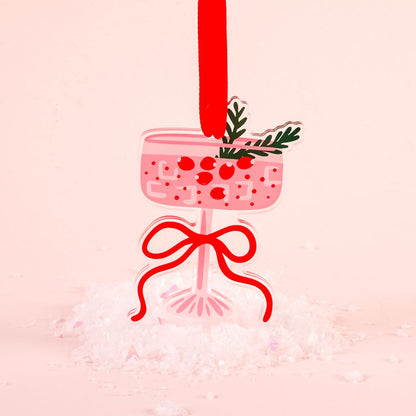 flat ornament of a pink cosmopolitan martini drink shown on a pink background