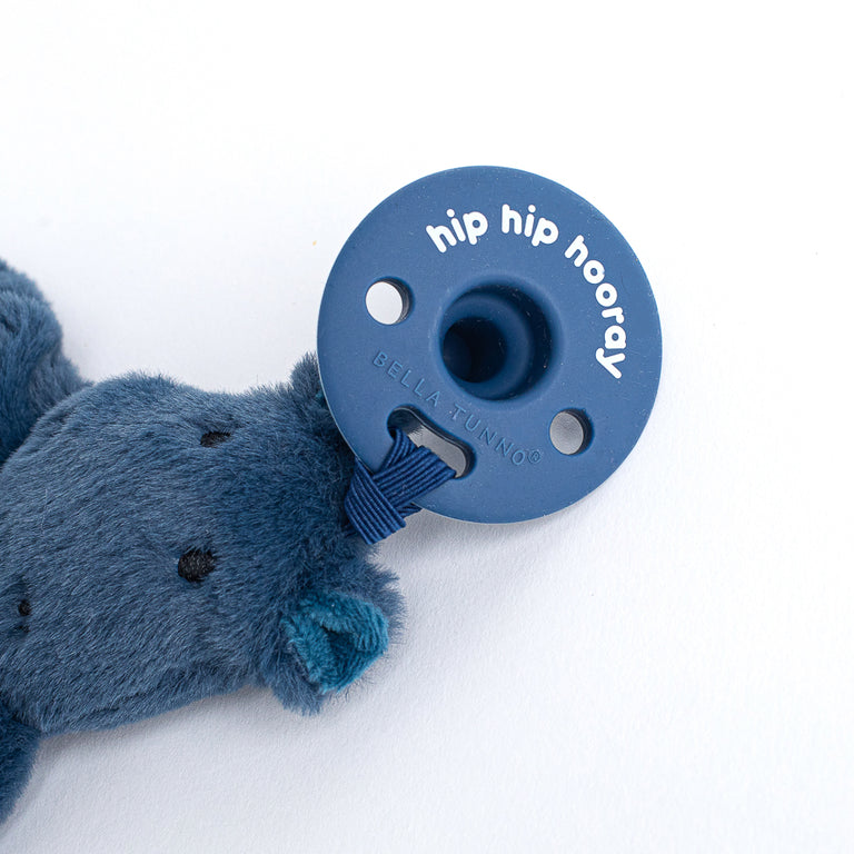 close-up of blue pacifier attached to hippo lovey.