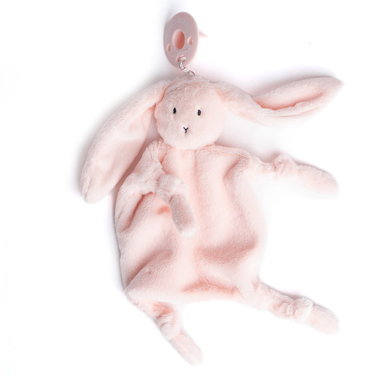 light pink bunny lovey with pacifier attach dfraped on a white background.