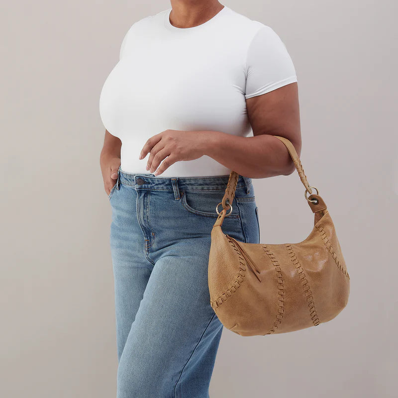 person carrying whiskey opal shoulder bag